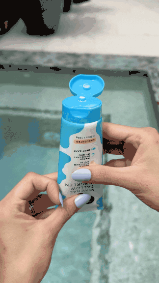 Squeezing HolyCow's Wildara Sunscreen by the pool